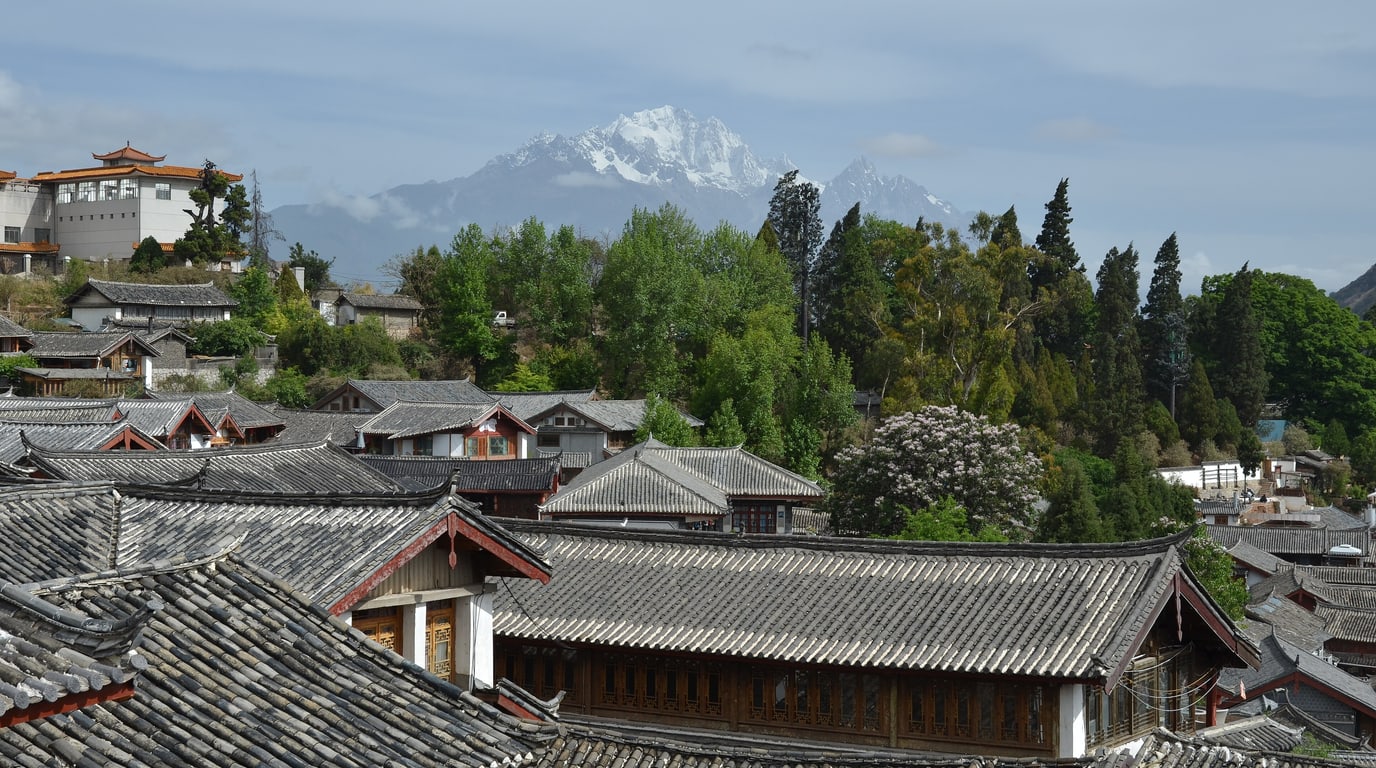 Stone roofs, lanes, and surrounding highlands in Lijiang old town